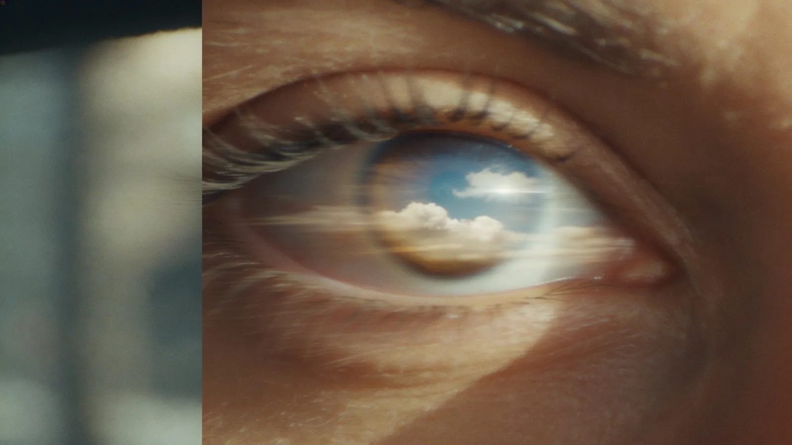 A luminous open eye in the TISHA grade, a blue sky and clouds reflected in the iris — the clarity that comes after work.